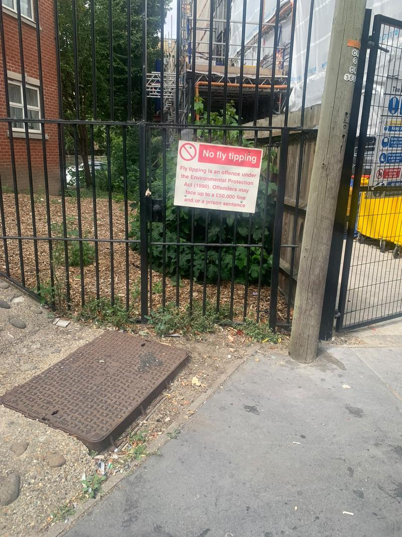 Fence and pavement after the pictured items were removed